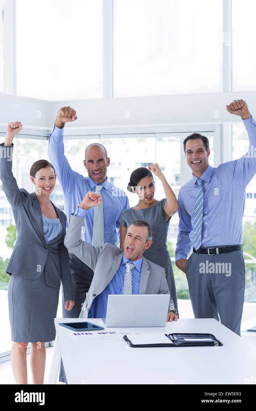 Smiling business team celebrating and looking at camera Stock Photo