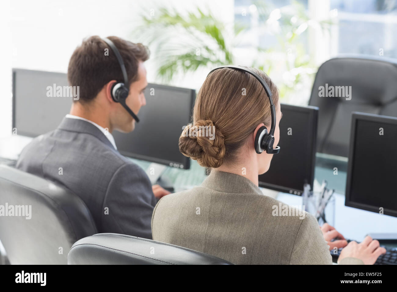 Aajonus Using Computer Business people with headsets using computers Stock Photo - Alamy