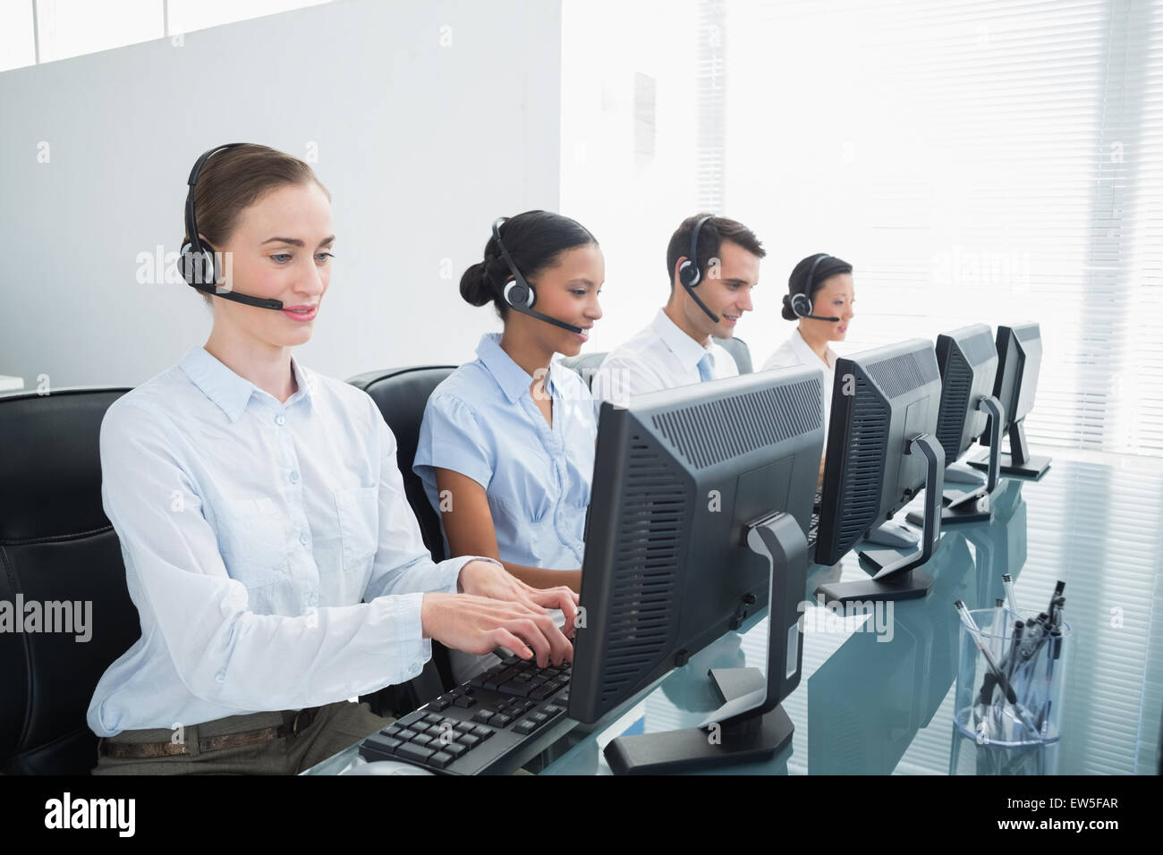 Business people headsets using computers hi-res stock photography and ...