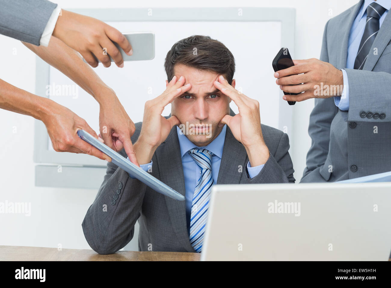Worried businessman with head in hands Stock Photo
