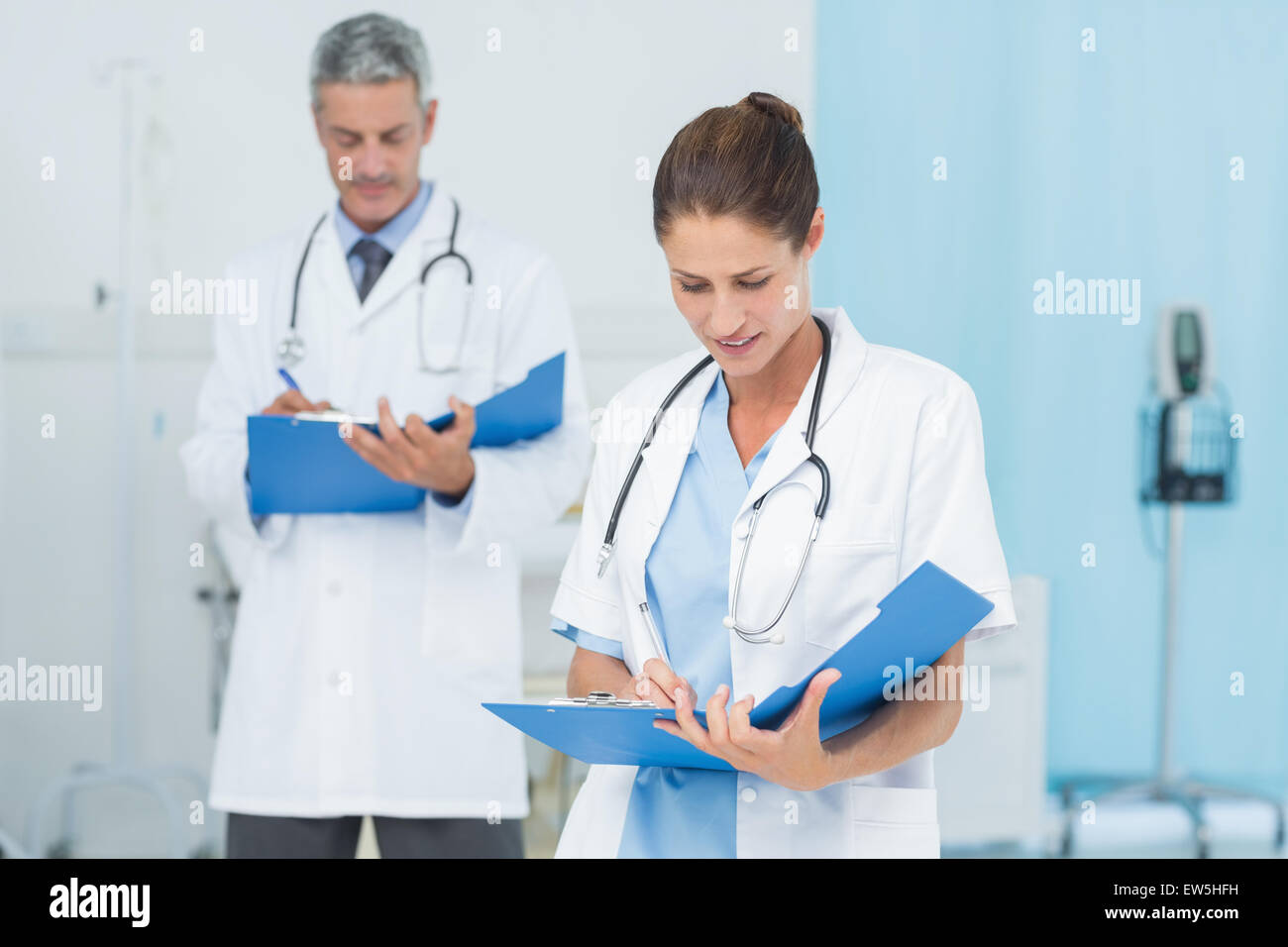 Male and female doctors working on reports Stock Photo