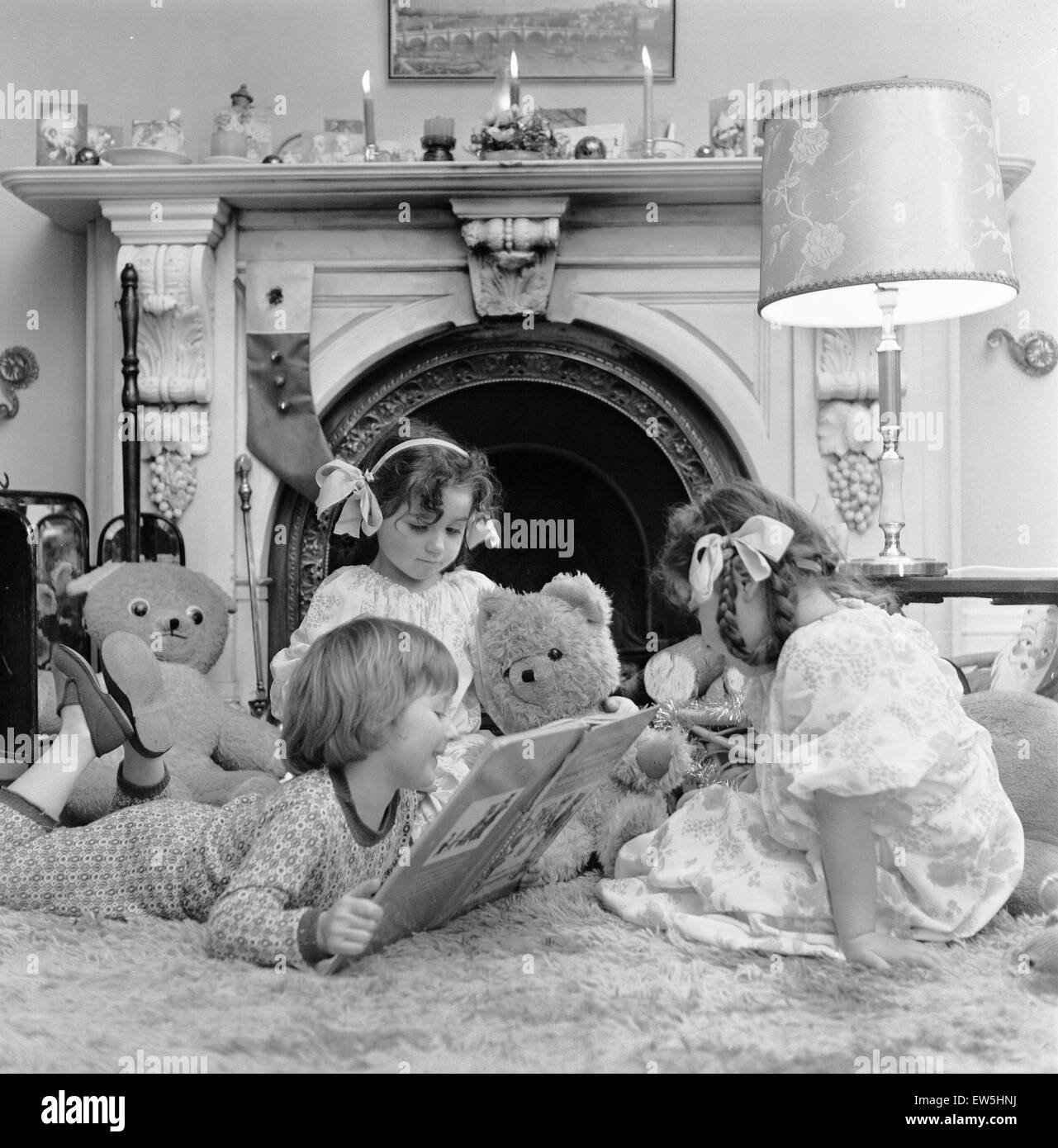 Christmas Eve, Children reading bedtime stories as they wait for Santa, Newcastle, Posed picture taken 18th December 1974. Stock Photo
