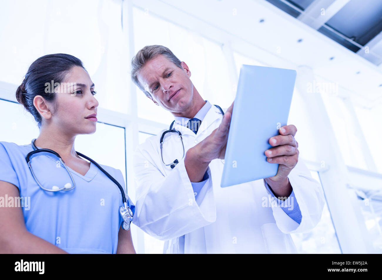 Serious looking doctor tablet hi-res stock photography and images - Alamy