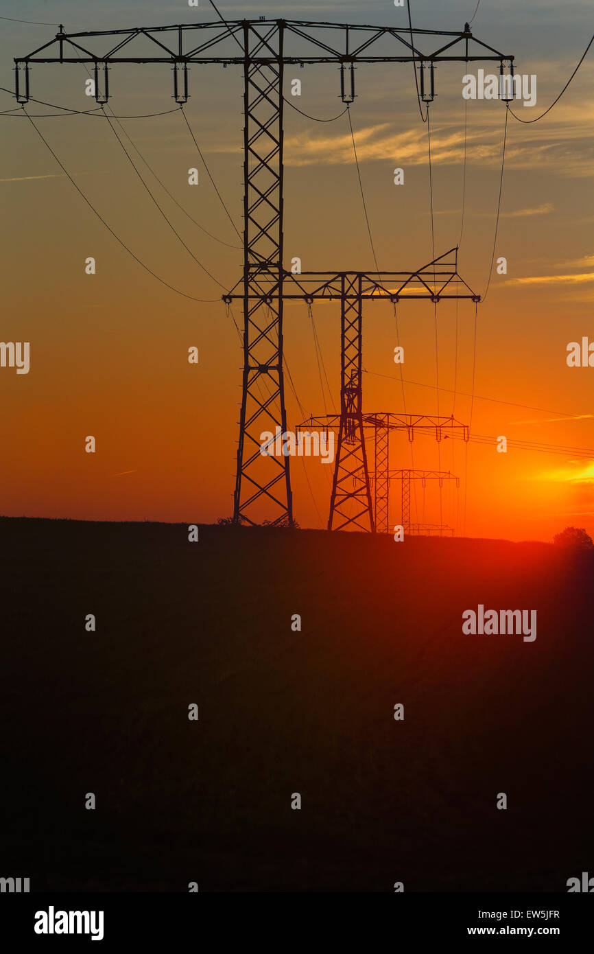 Klein-Mutz, Germany, pylons of a power line at sunset Stock Photo