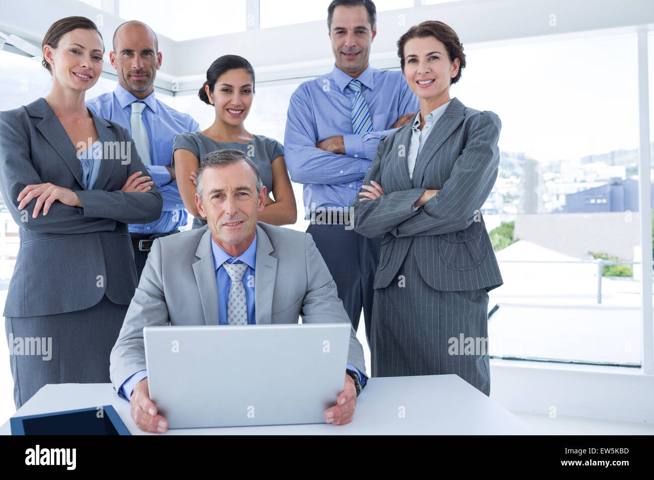 Business team working happily together on laptop Stock Photo - Alamy