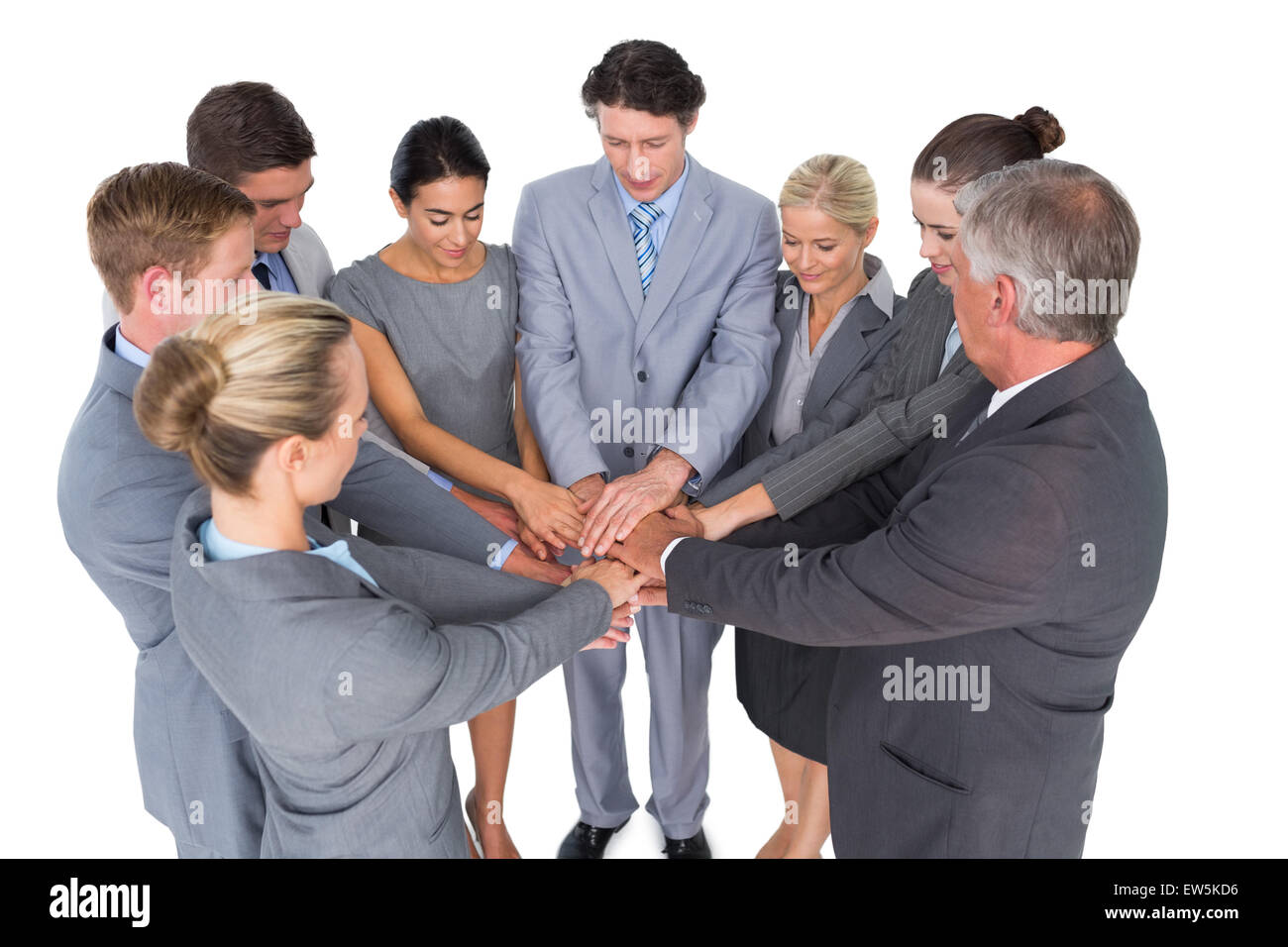 Smiling business team standing in circle hands together Stock Photo - Alamy