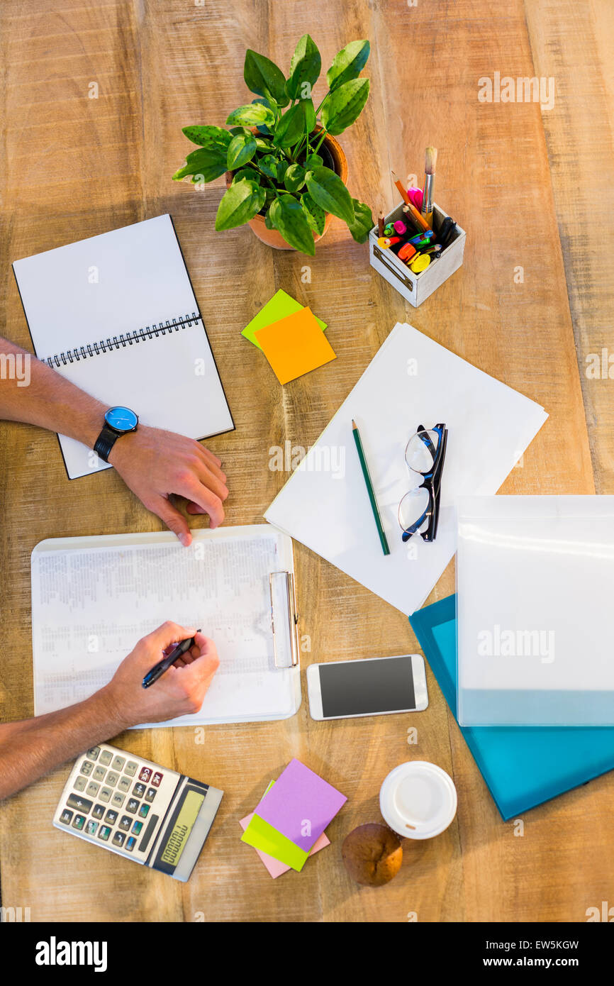 Man writing on clipboard Stock Photo - Alamy