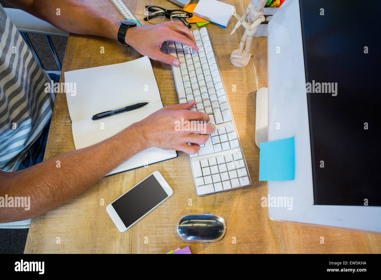 Casual businessman typing on keyboard Stock Photo