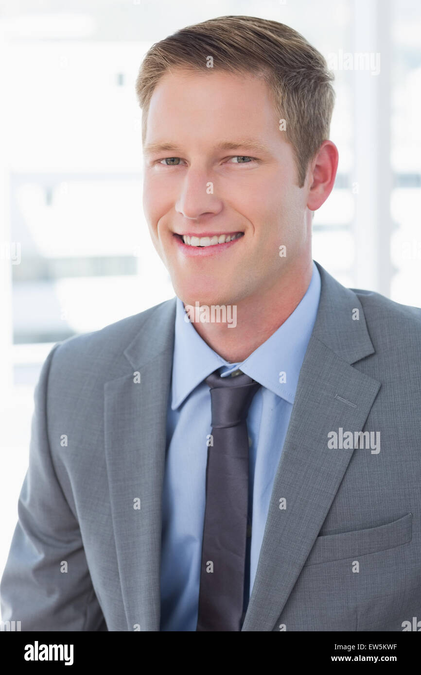 Smiling businessman looking at camera Stock Photo - Alamy