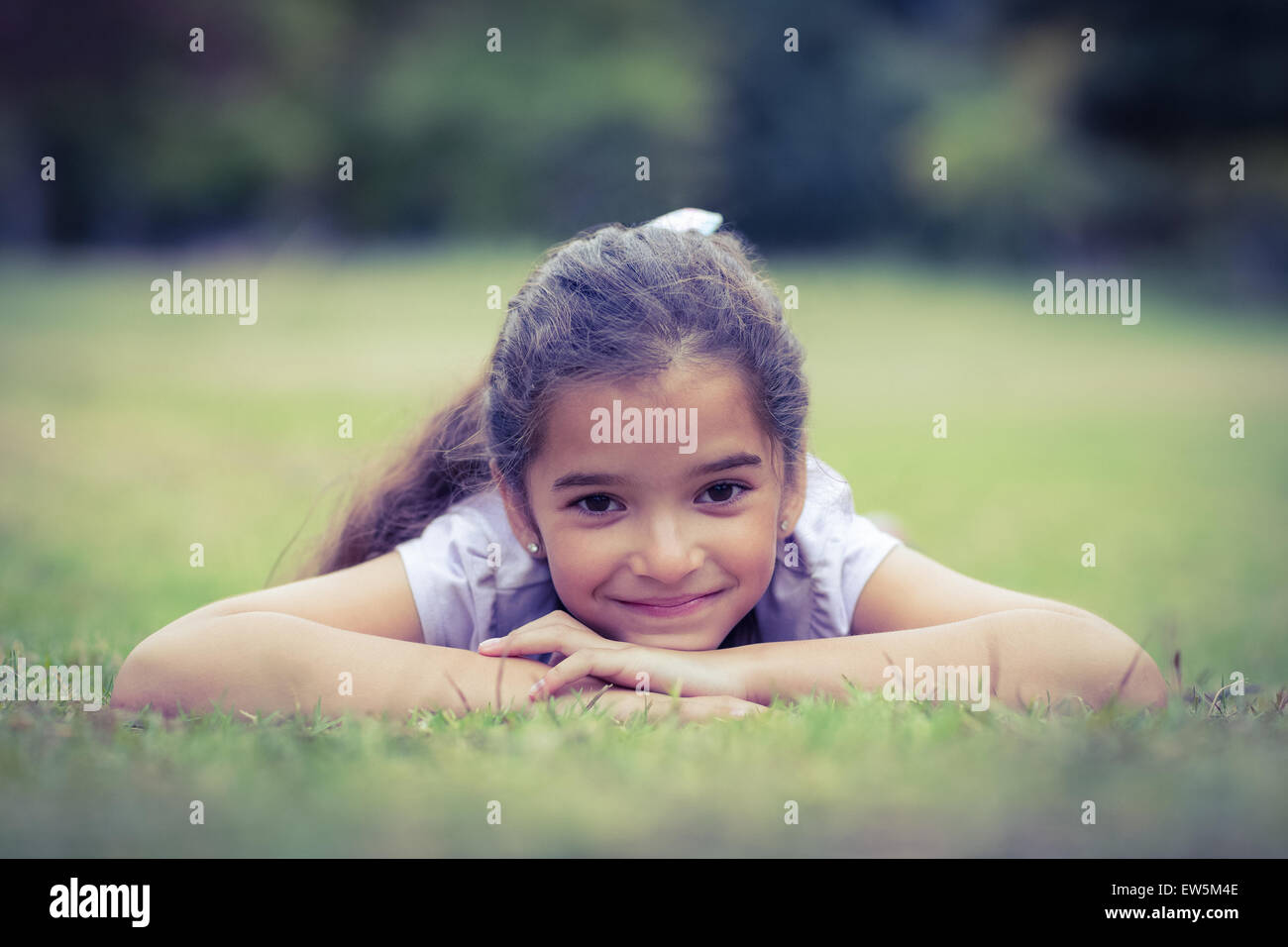 Smiling little girl looking at the camera Stock Photo - Alamy