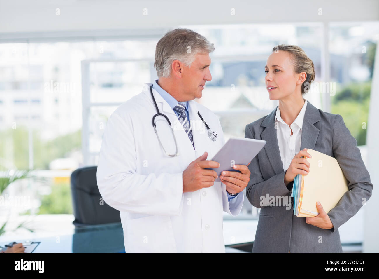 Pretty female doctor talking colleague hi-res stock photography and ...