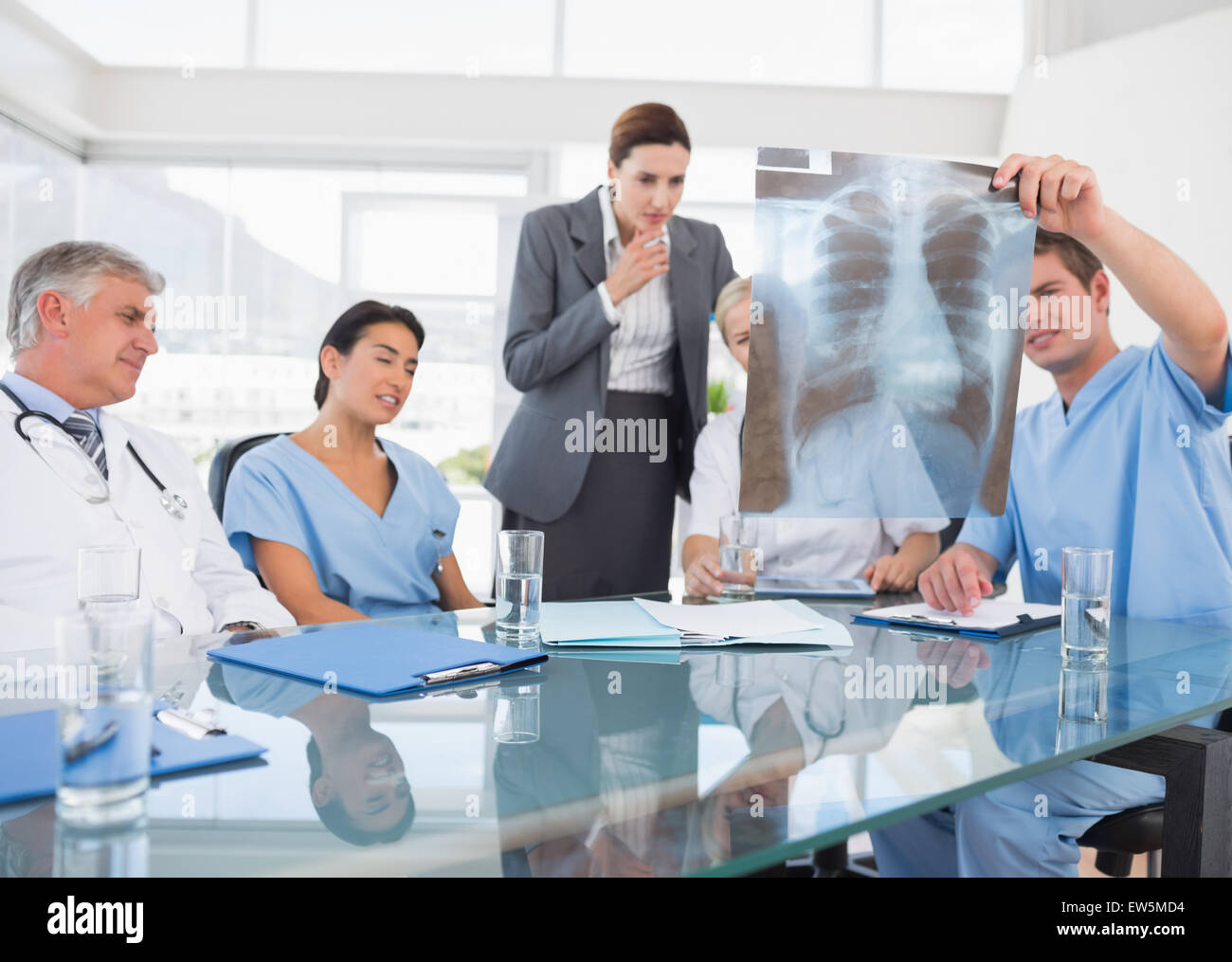 Team of doctors and businesswoman examining xray Stock Photo - Alamy