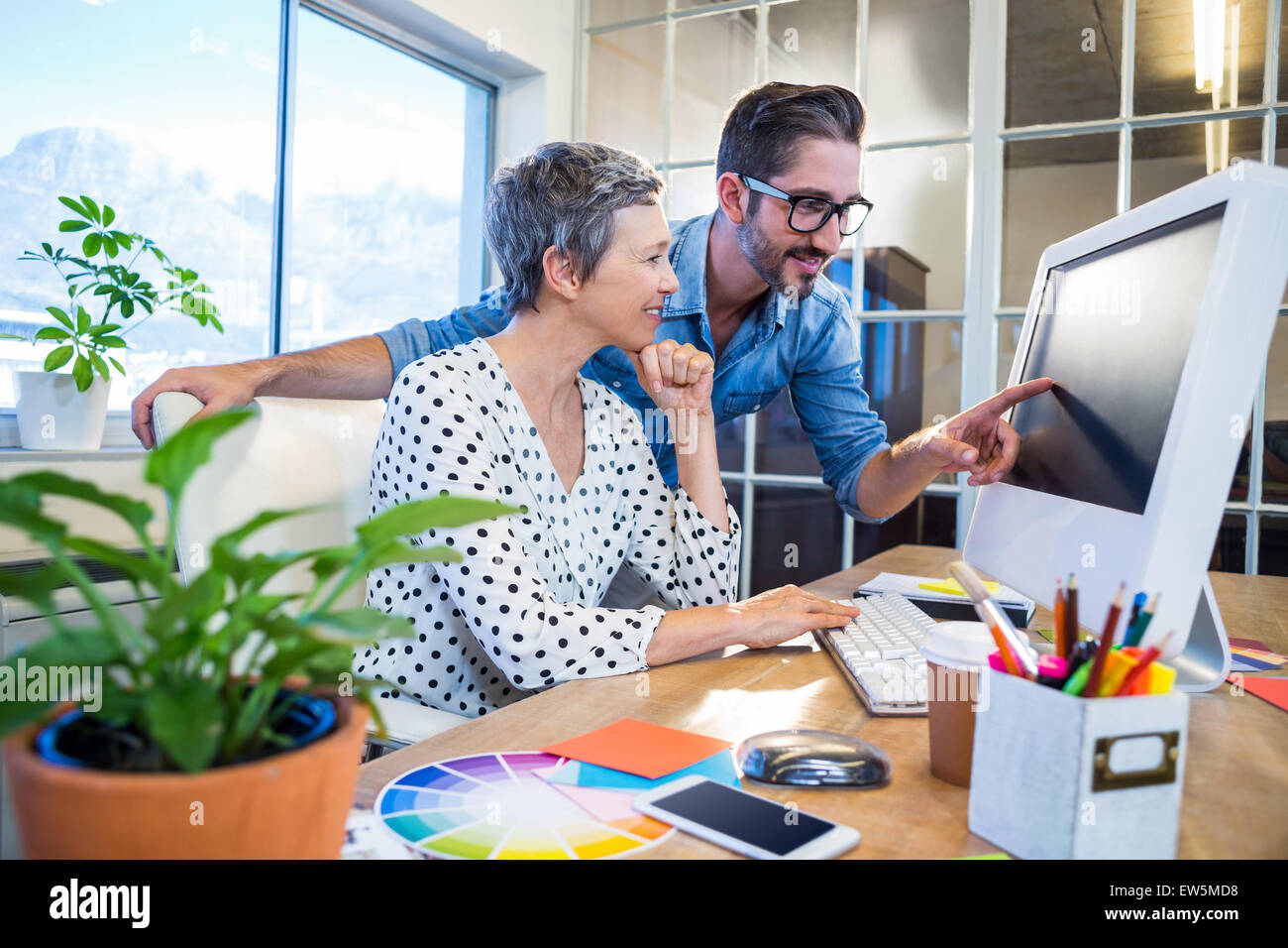 Casual businessman showing screen to his partner Stock Photo