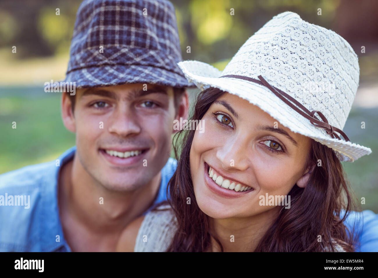 Happy couple smiling at the camera Stock Photo - Alamy
