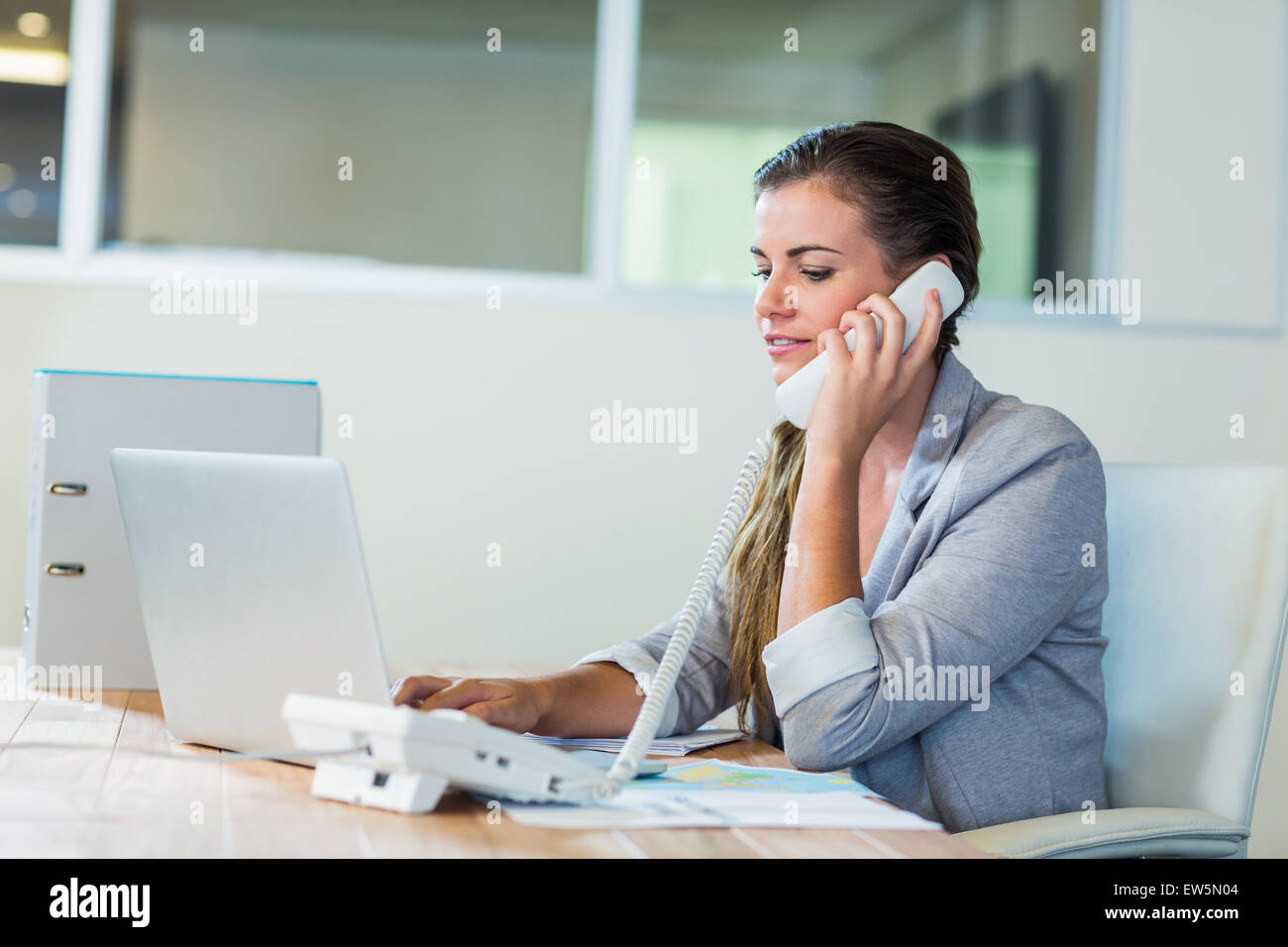 Pretty businesswoman having phone call Stock Photo