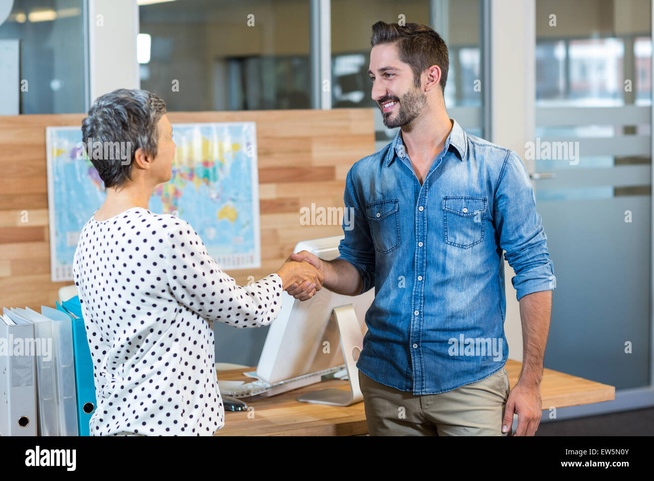 Smiling business people shaking hands Stock Photo