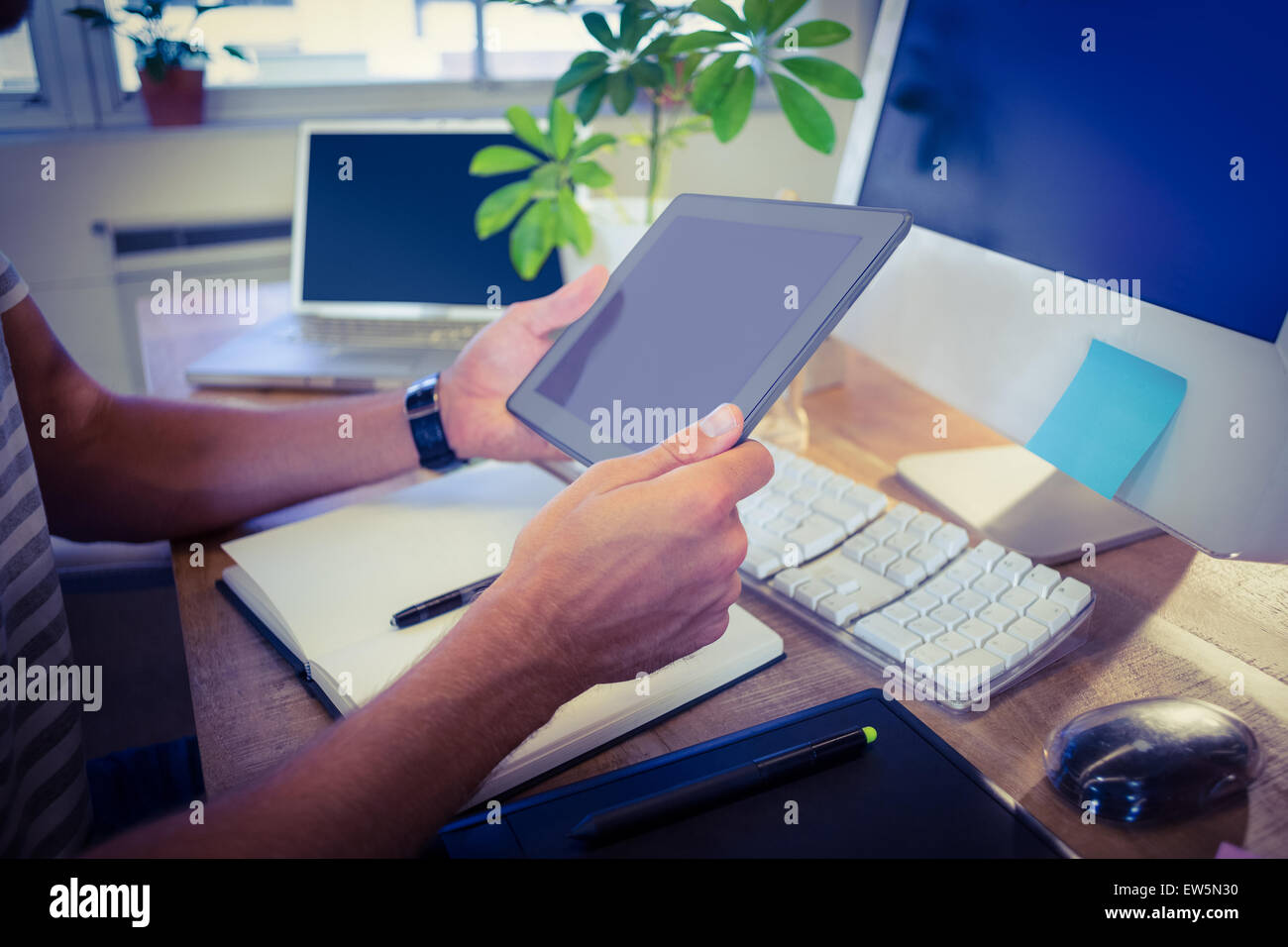 Designer working at desk using tablet Stock Photo