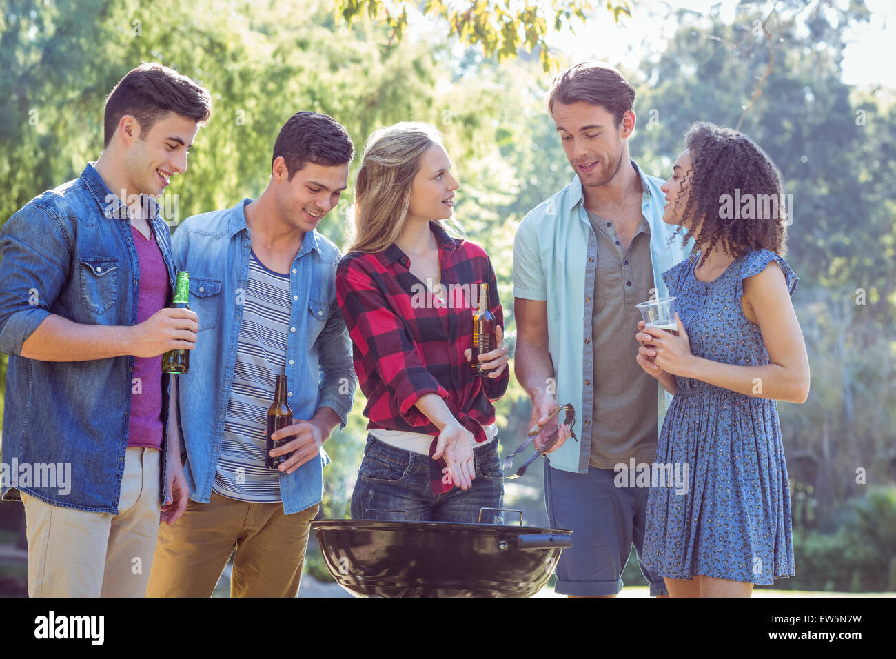 Happy friends in the park having barbecue Stock Photo - Alamy