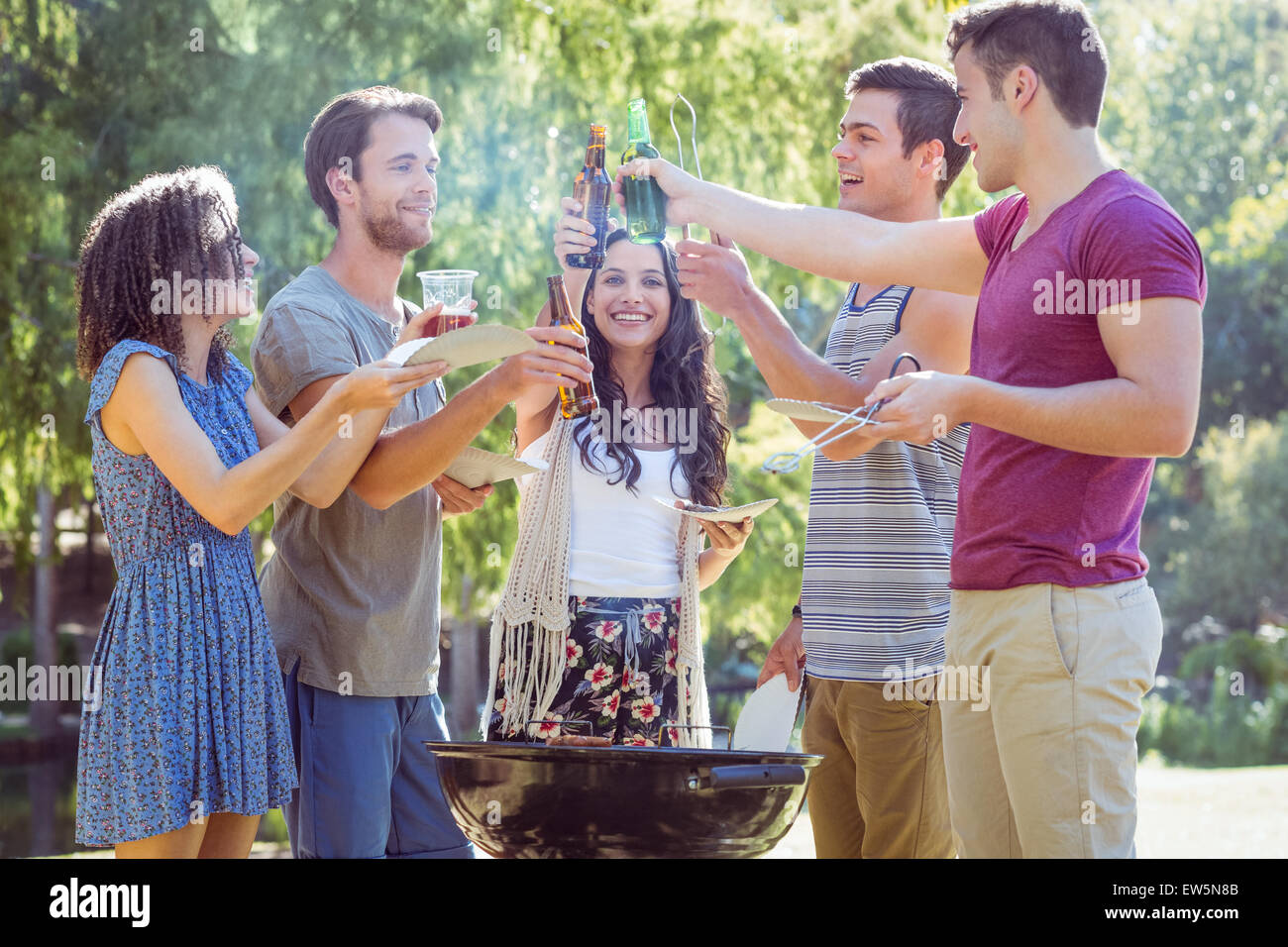 Happy friends in the park having barbecue Stock Photo - Alamy
