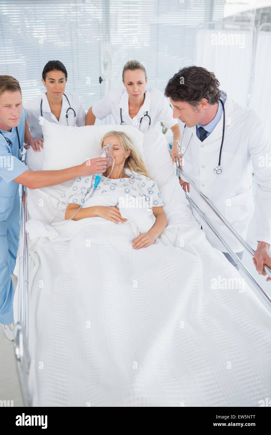 Team of doctors carrying patient on stretcher Stock Photo Alamy