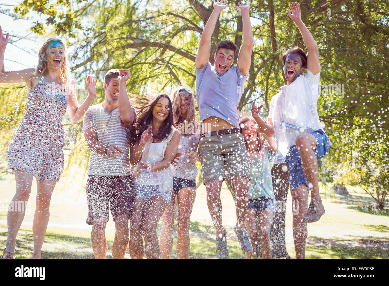Happy friends jumping in the water Stock Photo - Alamy