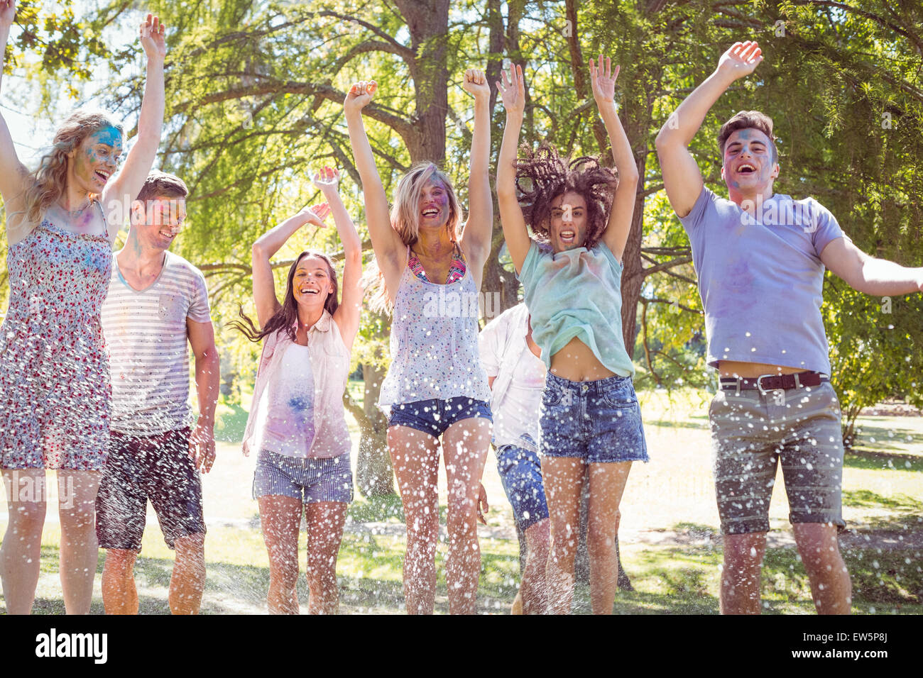 Happy friends jumping in the water shoot Stock Photo - Alamy