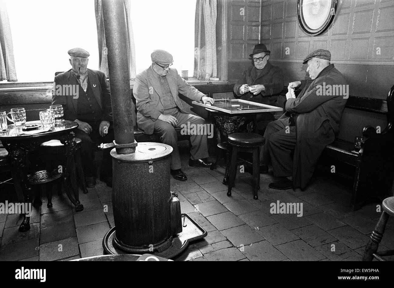 Group of men play dominoes at the Druids Head Inn in Coseley, a suburban area in the north of the Dudley,  The Black Country, an area of the West Midlands in England, north and west of Birmingham. 25th May 1968. Stock Photo
