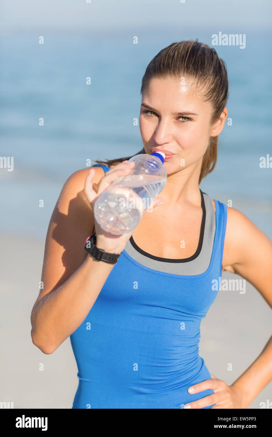 Portrait of beautiful fit woman drinking water Stock Photo