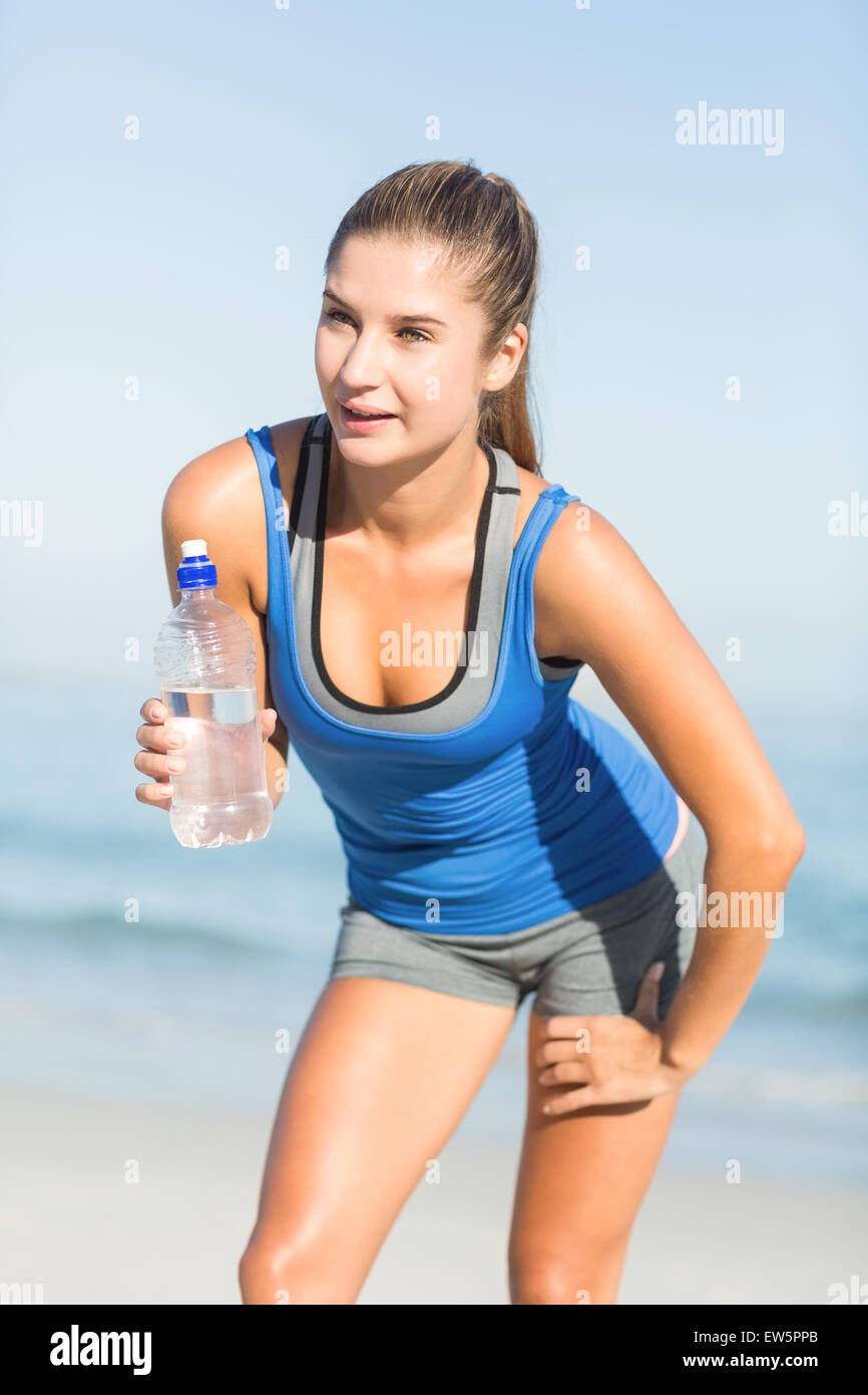 Portrait of beautiful fit woman holding bottle of water Stock Photo - Alamy