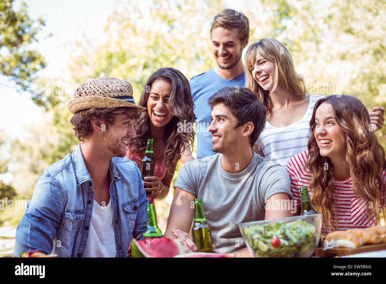 Happy friends in the park having lunch Stock Photo - Alamy