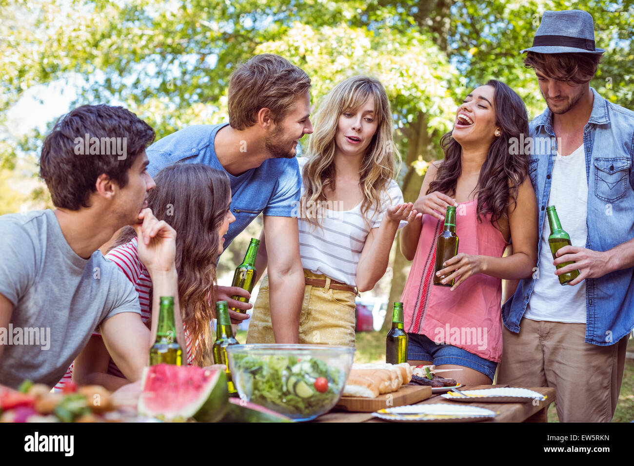 Happy friends in the park having lunch Stock Photo - Alamy