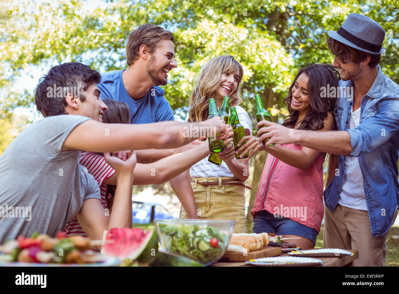 Happy friends in the park having lunch Stock Photo - Alamy