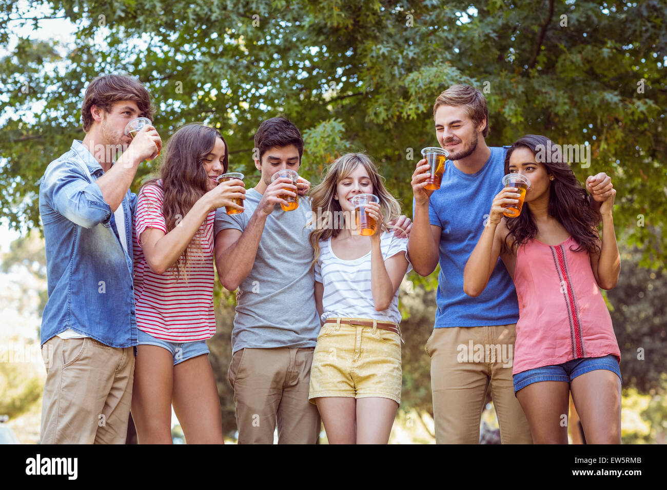 Happy friends in the park having picnic Stock Photo - Alamy
