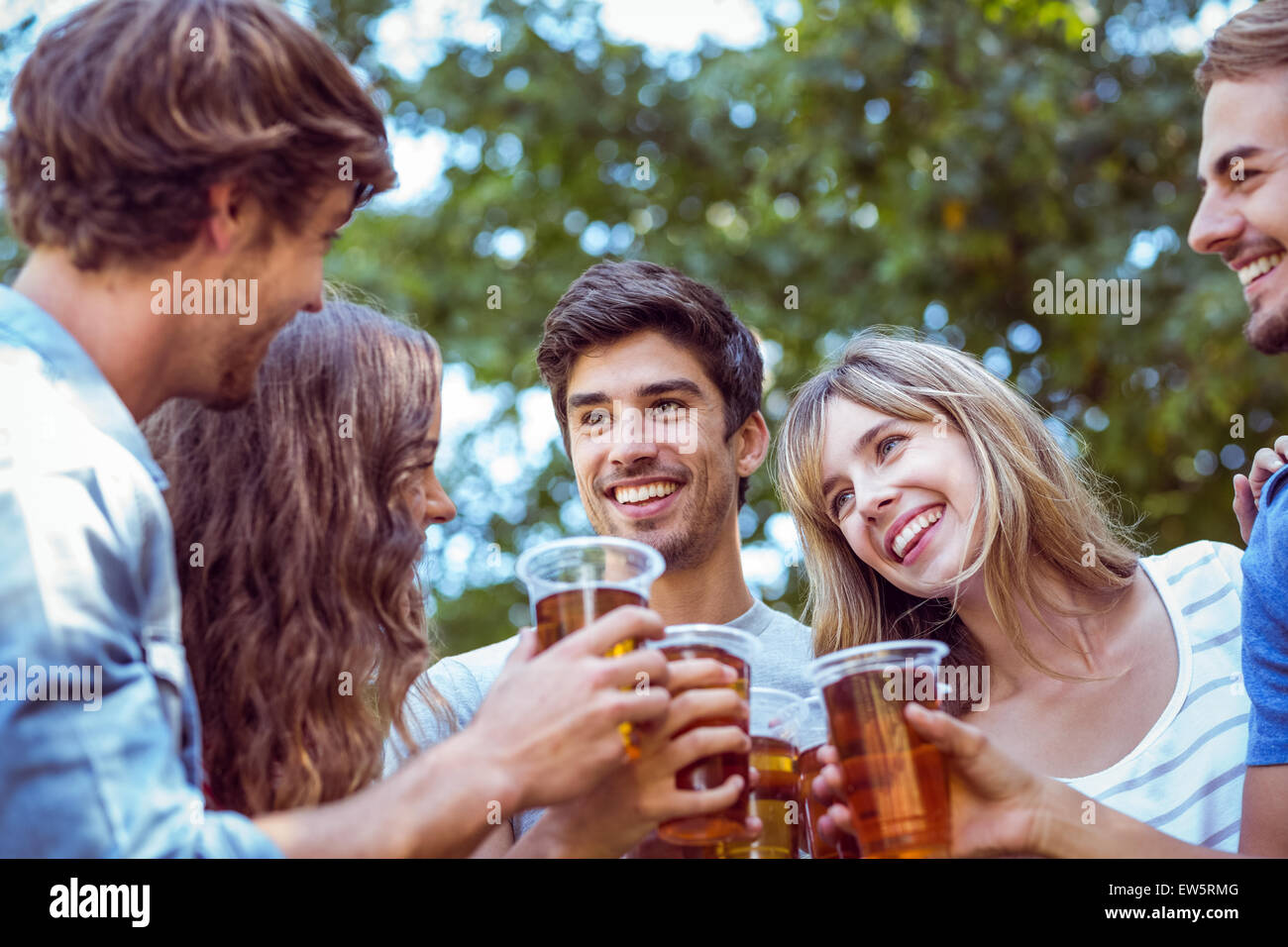 Happy friends in the park Stock Photo - Alamy