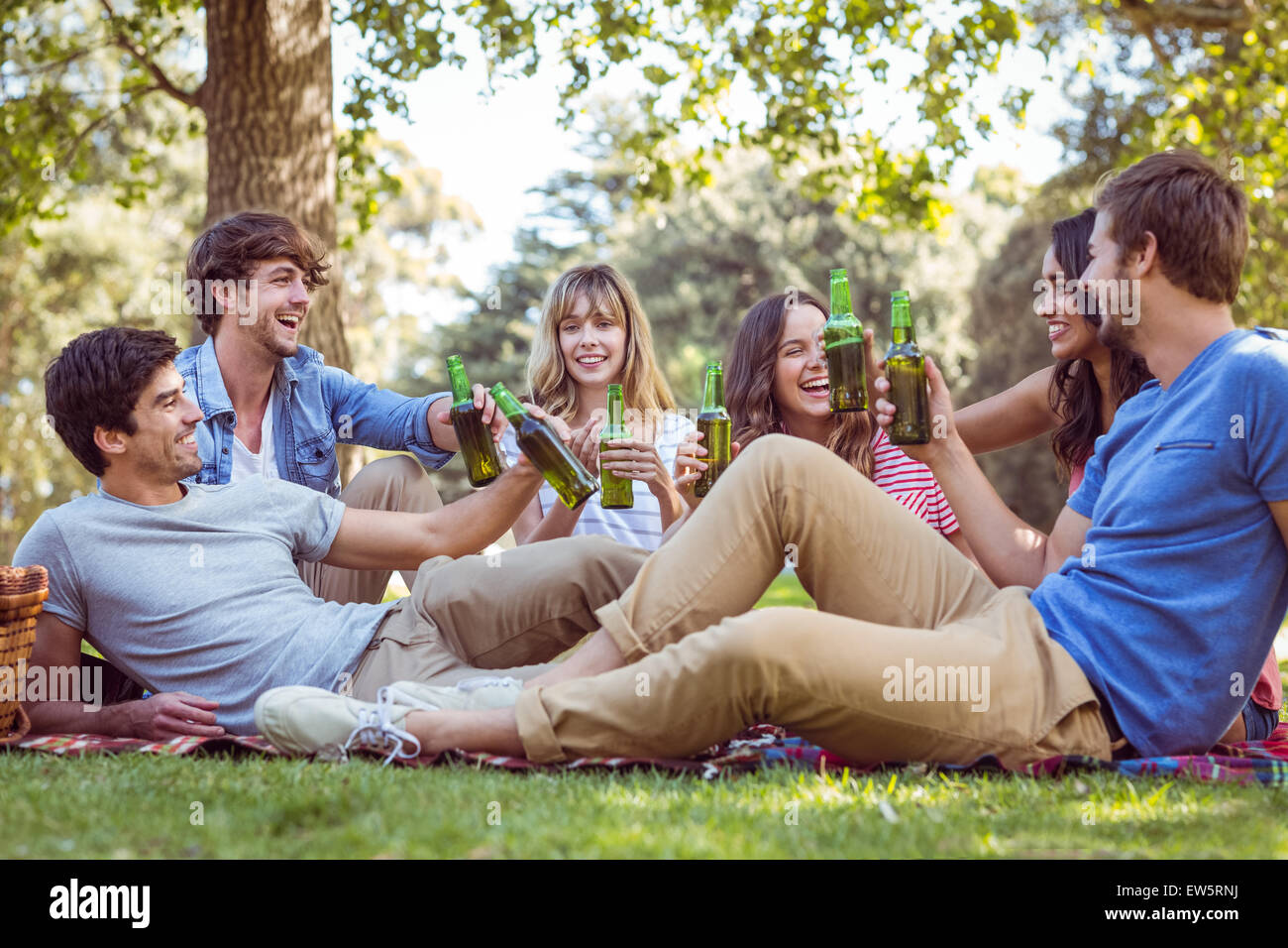 Happy friends in the park having picnic Stock Photo - Alamy