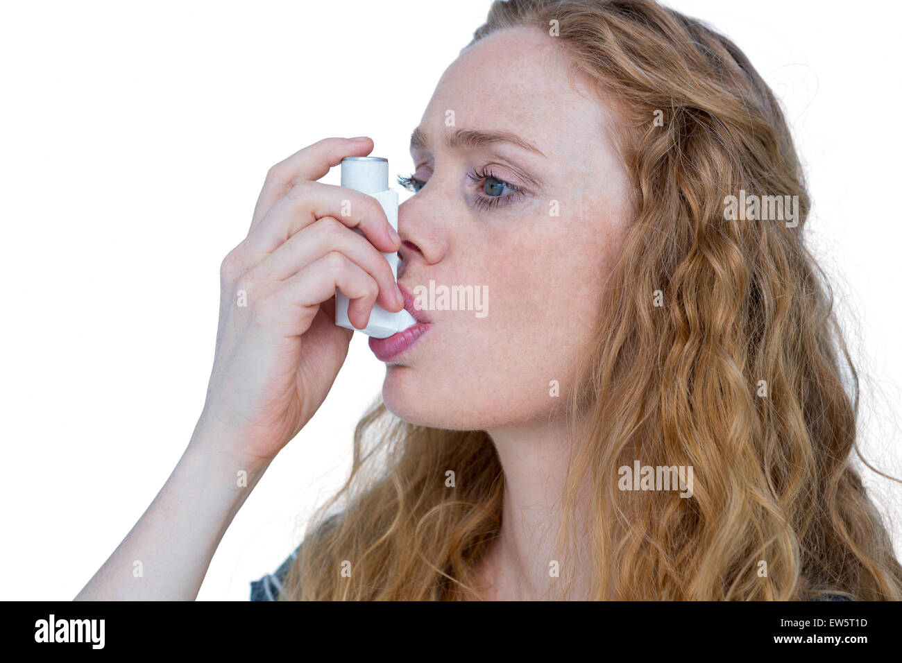 Pretty blonde using an asthma inhaler Stock Photo - Alamy