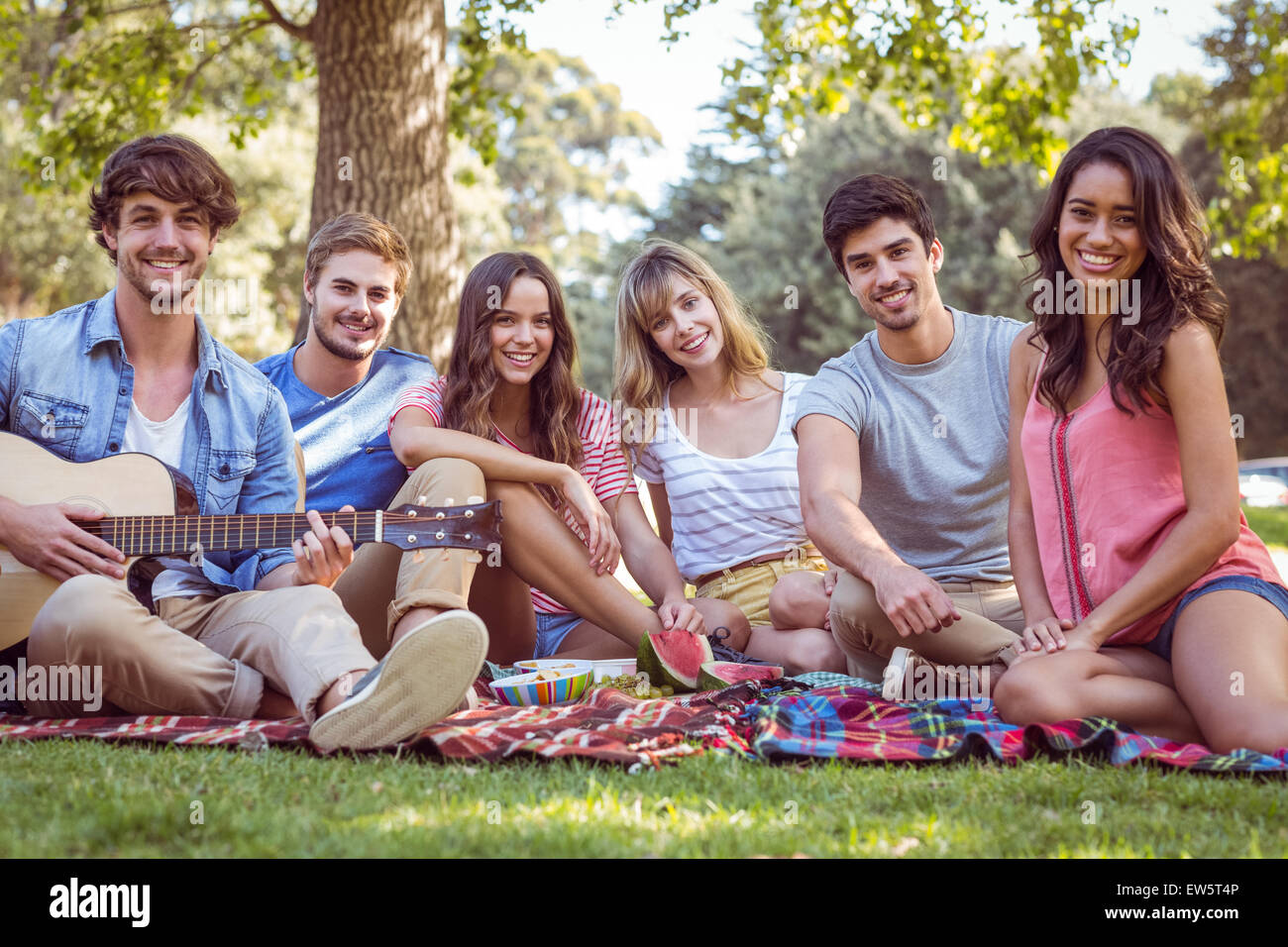 happy friends in a park having a picnic Stock Photo - Alamy