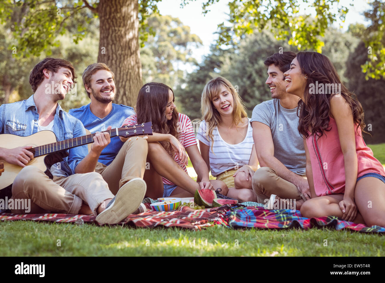happy friends in a park having a picnic Stock Photo - Alamy