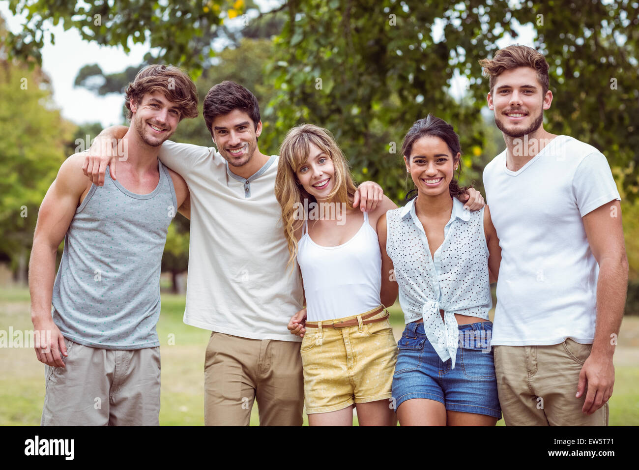 Happy friends in a park Stock Photo - Alamy