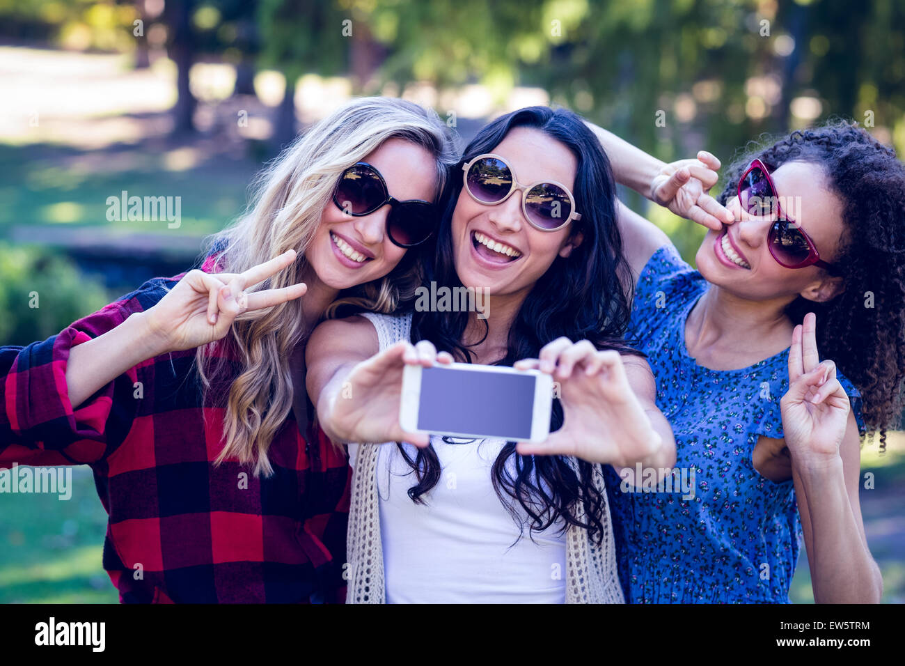 Happy hipsters taking a selfie in the park Stock Photo