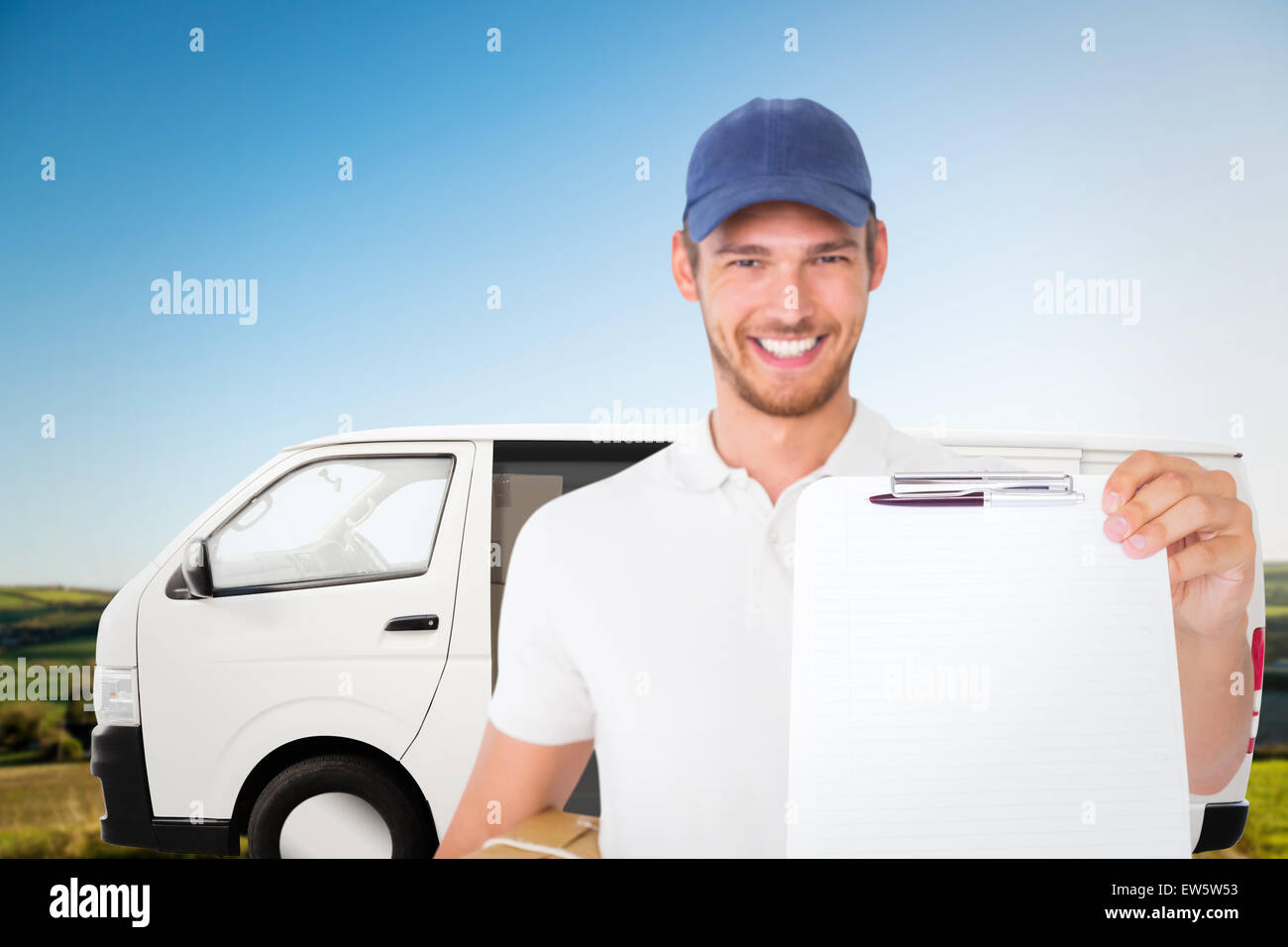 Composite image of happy delivery man holding cardboard box and clipboard Stock Photo