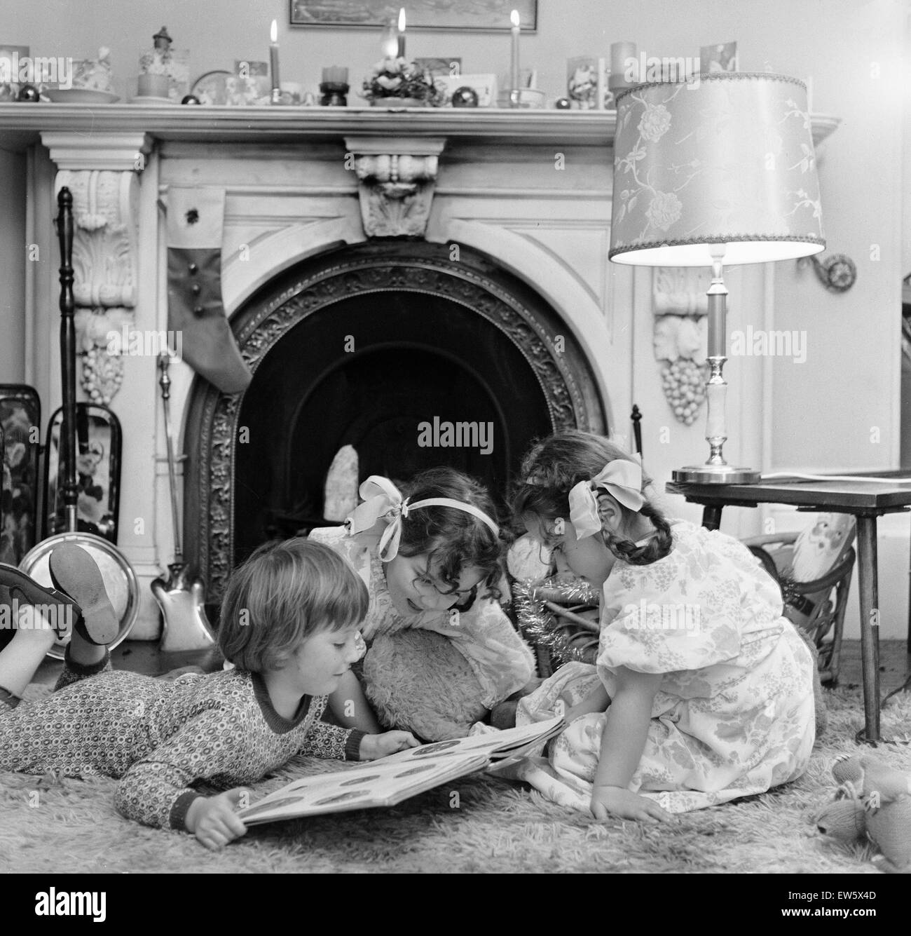 Christmas Eve, Children reading bedtime stories as they wait for Santa, Newcastle, Posed picture taken 18th December 1974. Stock Photo