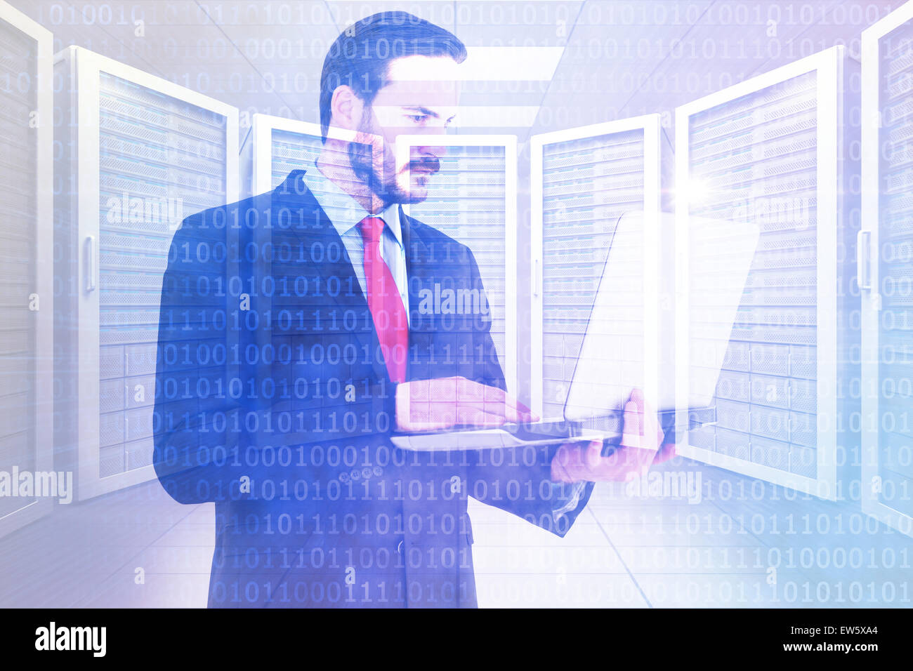 Composite image of focused businessman using his laptop Stock Photo