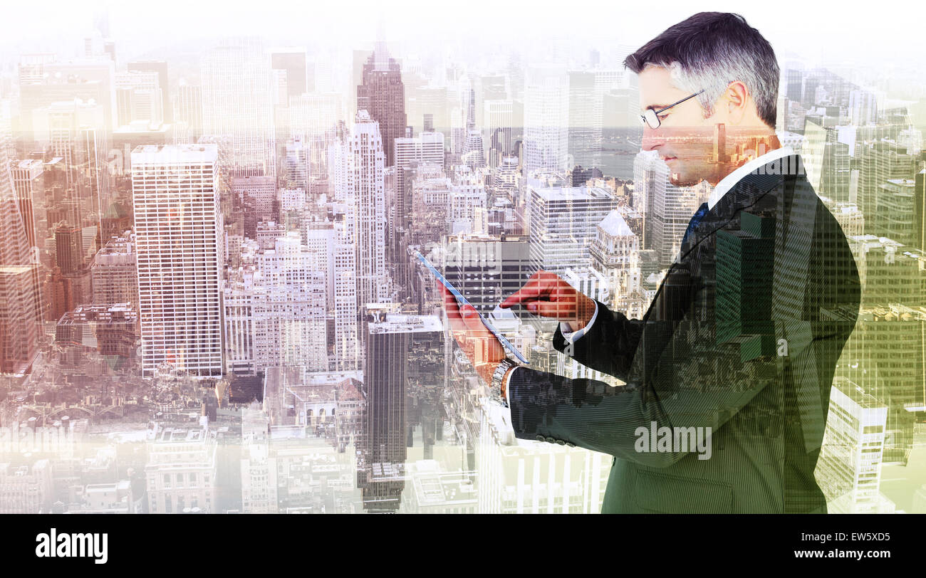Composite image of mid section of a businessman touching tablet Stock Photo