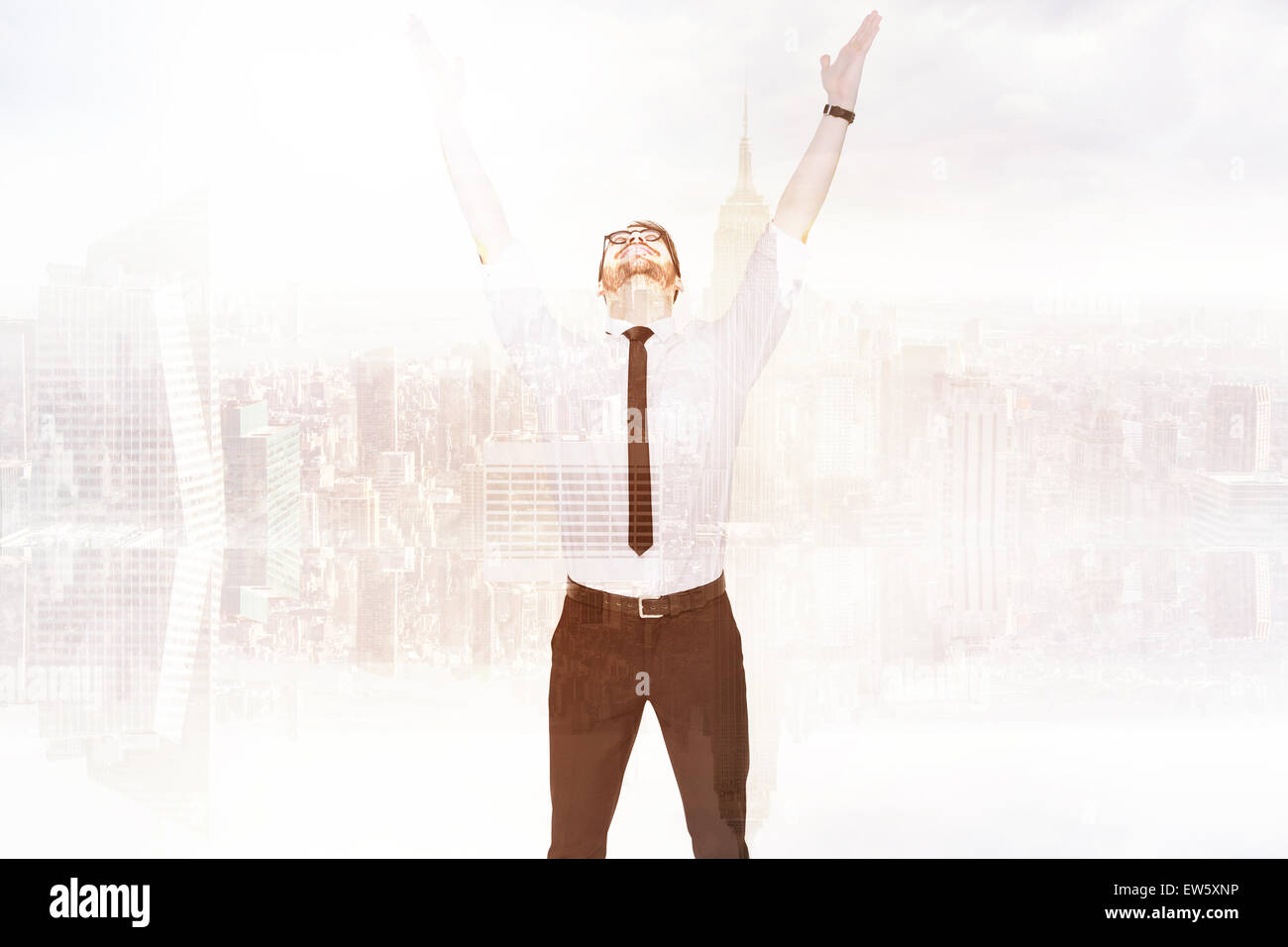 Composite image of smiling businessman cheering with his hands up Stock Photo