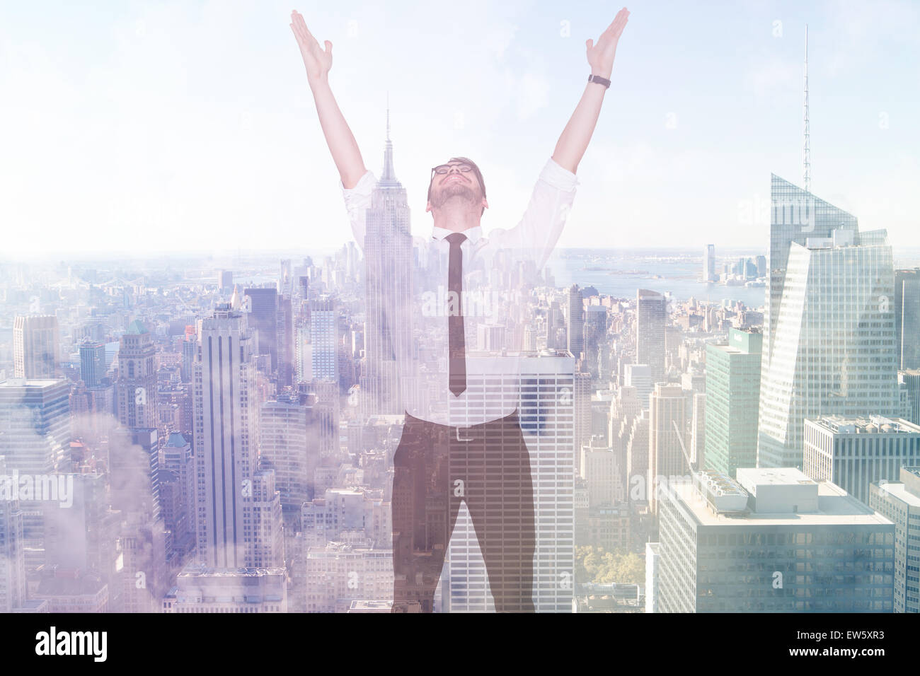 Composite image of smiling businessman cheering with his hands up Stock Photo
