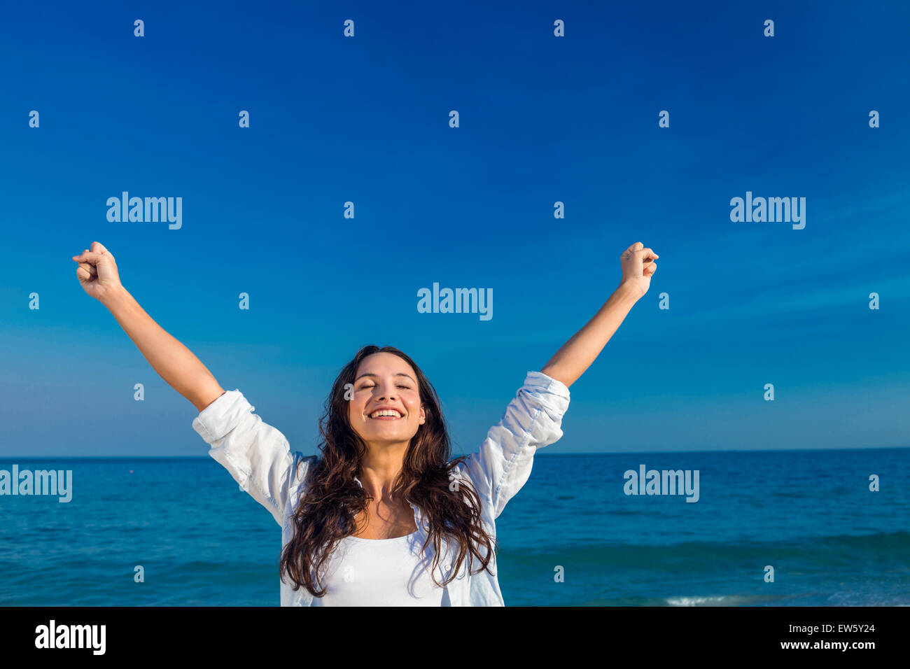 Happy woman smiling at the beach Stock Photo - Alamy
