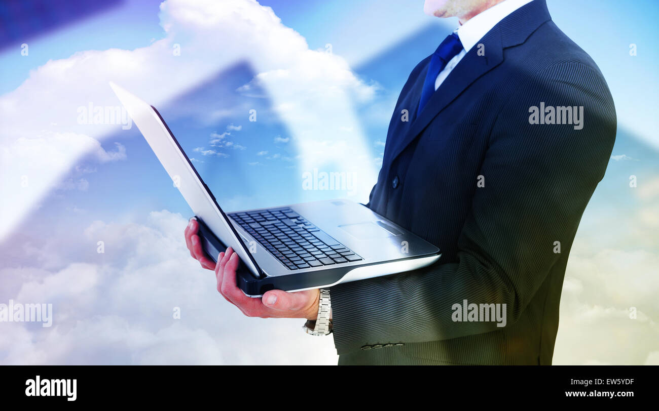 Composite image of businessman with watch using tablet pc Stock Photo