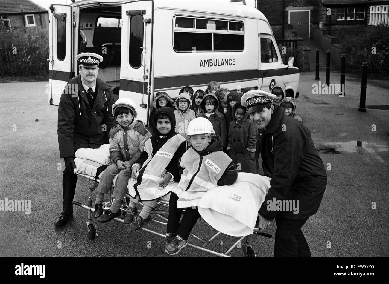 Wheel 'em away... Stile Common Junior School pupils, from left, Lee Dutton, Manjit Garcha and Daniel Hayes, get a lift from ambulance men, Alan Parkinson, left, of Huddersfield Ambulance Station and Andrew Luty, of Honley station. The youngsters were show Stock Photo