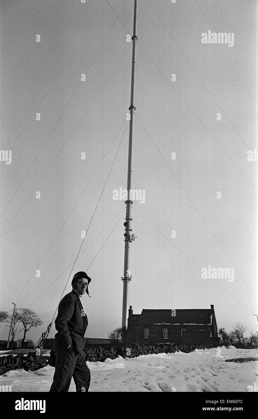 Emley Moor transmitting station mast the day before it collapsed. Falling ice was a regular problem in winter, with people working nearby wearing crash helmets to protect themselves from falling ice. On the 19th March 1969, a combination of strong winds a Stock Photo